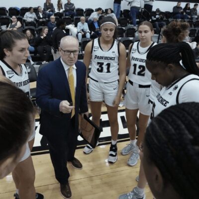 A group of women's basketball players in a huddle.