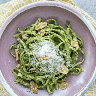 Green pesto pasta with walnuts and parmesan cheese.