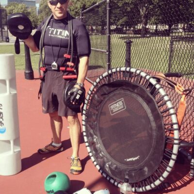 A man standing next to a trampoline.