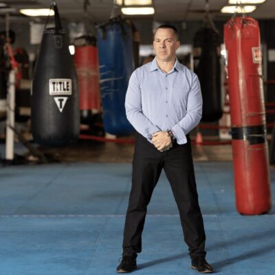 A man standing in front of a boxing ring.