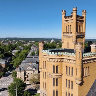 An aerial view of an old building with a clock tower.