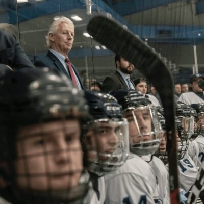 A group of hockey players are on the bench.