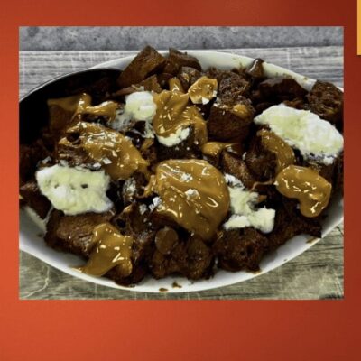 A plate of meat and gravy on a red background.