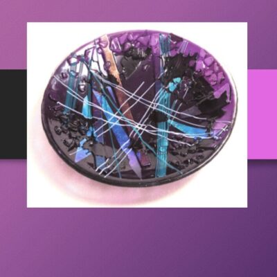 A purple and blue plate displayed against a vibrant purple background, showcasing artistic beauty.