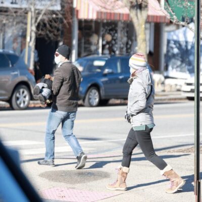 A man and woman walking down a city street.