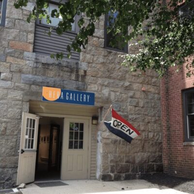 The entrance to an art gallery with a flag.