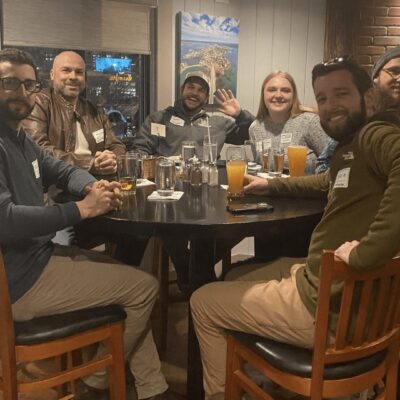 A group of people sitting around a table.