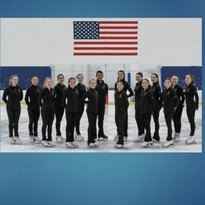 A group of ice skaters posing in front of an american flag.