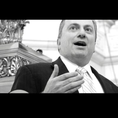 A black and white photo of a man in a suit and tie.