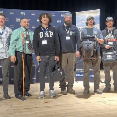 A group of people posing for a photo in front of a banner.