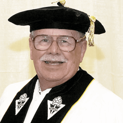 A man wearing a robe and hat, representing Providence College.