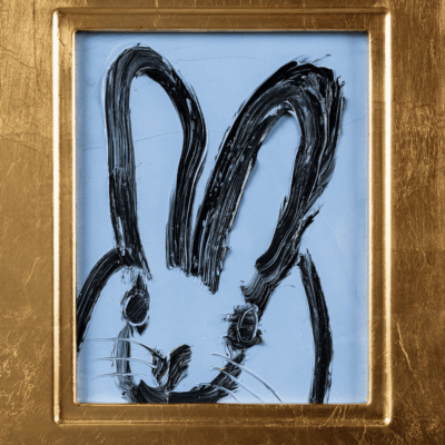 A black and blue bunny in a gold frame, created by Hunt Slonem.