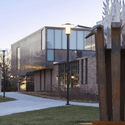 A statue of a bird in front of a building.