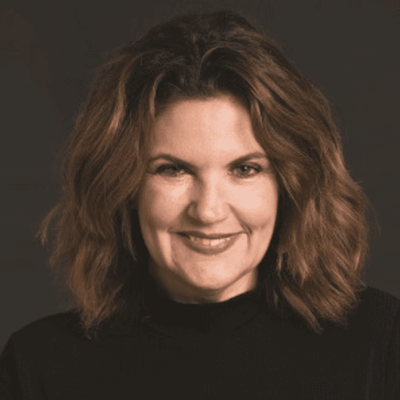 A black and white photo of a woman smiling.
