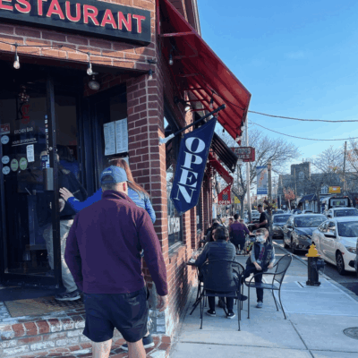 A brick building in Providence with a red door.