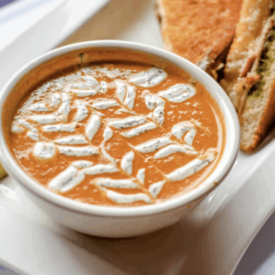         A bowl of soup and a sandwich on a plate, perfect for quick and easy recipes.