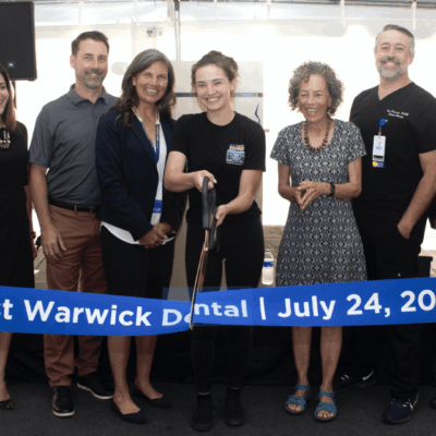 A group of people standing in front of a tent.