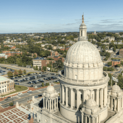 An aerial view of a cityscape from the top of a masonry building.