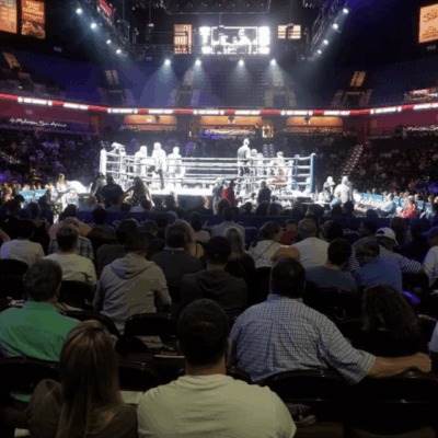 A crowd of people watching a CES Boxing match.