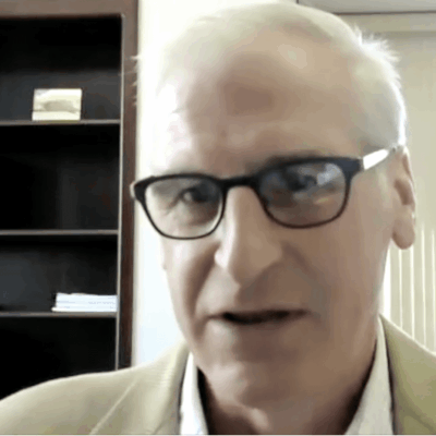 A man wearing glasses and a blazer in a Providence office.