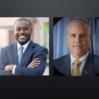 Two men in suits, Gabe and Amo, standing next to each other.