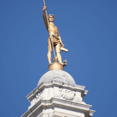 The statue of Independent Man proudly stands atop a majestic clock tower.