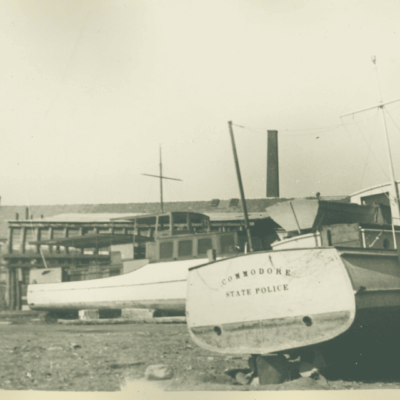 A picture of a boat docked in the dirt.