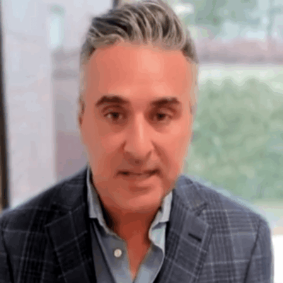 A man in a suit is looking at the camera during an election.