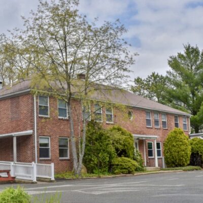 A brick building in Rhode Island with a picnic table.