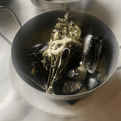 Delicious Mussels recipes in a pot on a white plate.