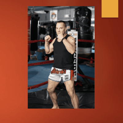 A man is exercising in a boxing ring.