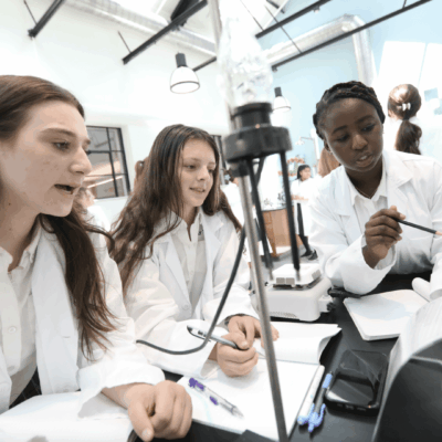 A group of women in lab coats from Bay View working together.