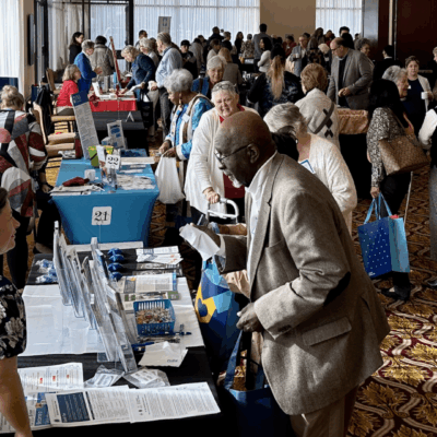 A group of people standing around a table at an event.