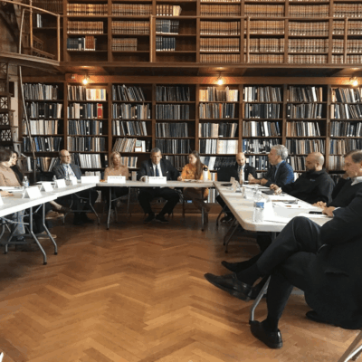 A group of people sitting around a table in a library at the Rhode Island State Archives.