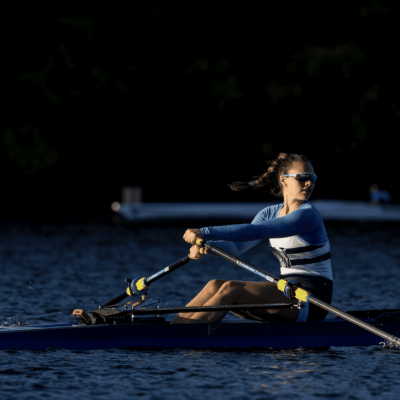 A woman is engaging in rowing.
