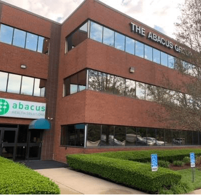 A building with landscaped gardens in front of it.