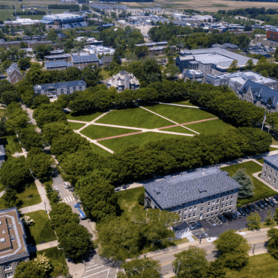 An aerial view of the Soloviev campus with green grass and trees.