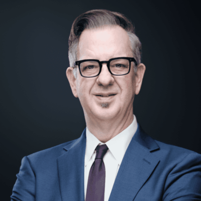 A man in a suit and tie posing for a photo.