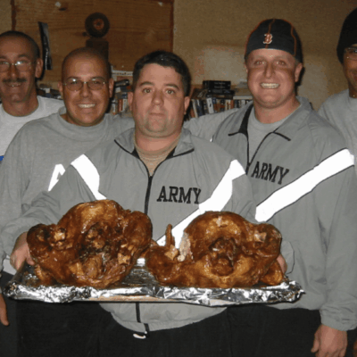 A group of veterans posing with turkeys.