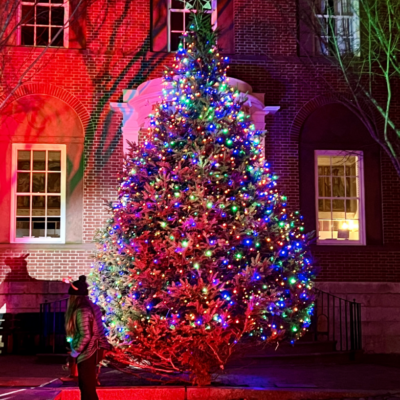 A large Christmas tree lit up in front of a building on Nantucket.