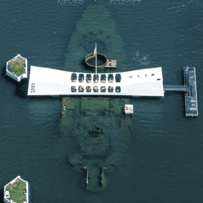 A boat is floating in the water, while a group of veterans stand on its deck, reminiscing about their service.