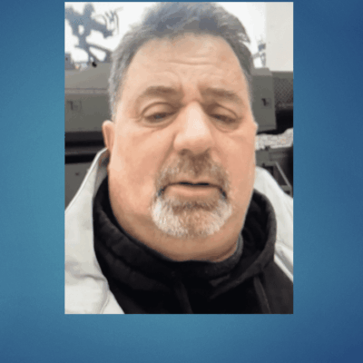 An image of a man at the Army Navy Game with his eyes closed.