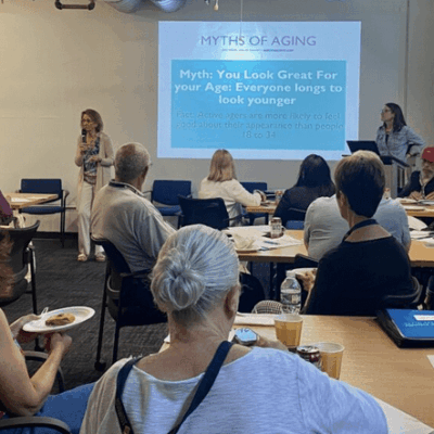 Leadership Rhode Island participants sitting at tables and attentively listening to a presentation.