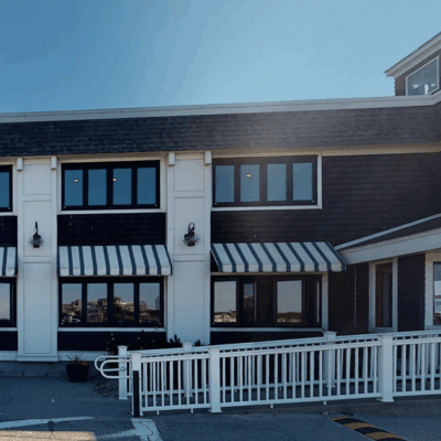 A networked building with a white fence.