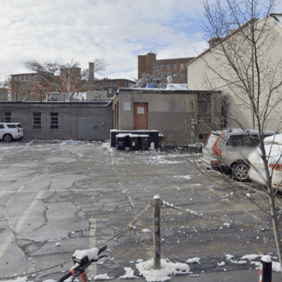An architecturally-designed parking lot with cars parked in it.