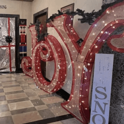 A large sign in Pawtucket with the word joy in front of it.