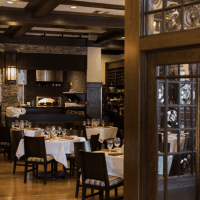 A dining room with tables and chairs.