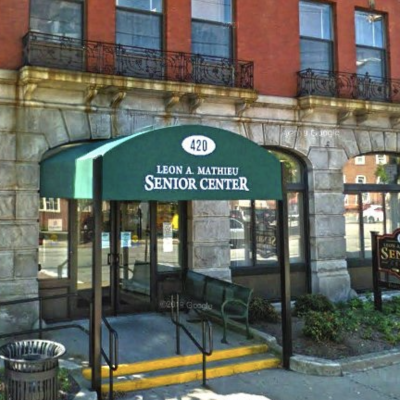 A building with a green awning in front of it.