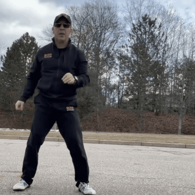 A man in a black jacket is standing in a parking lot, ready to "burn with Kearns.