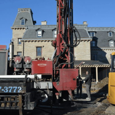 A yellow truck with a geothermal drill on it.